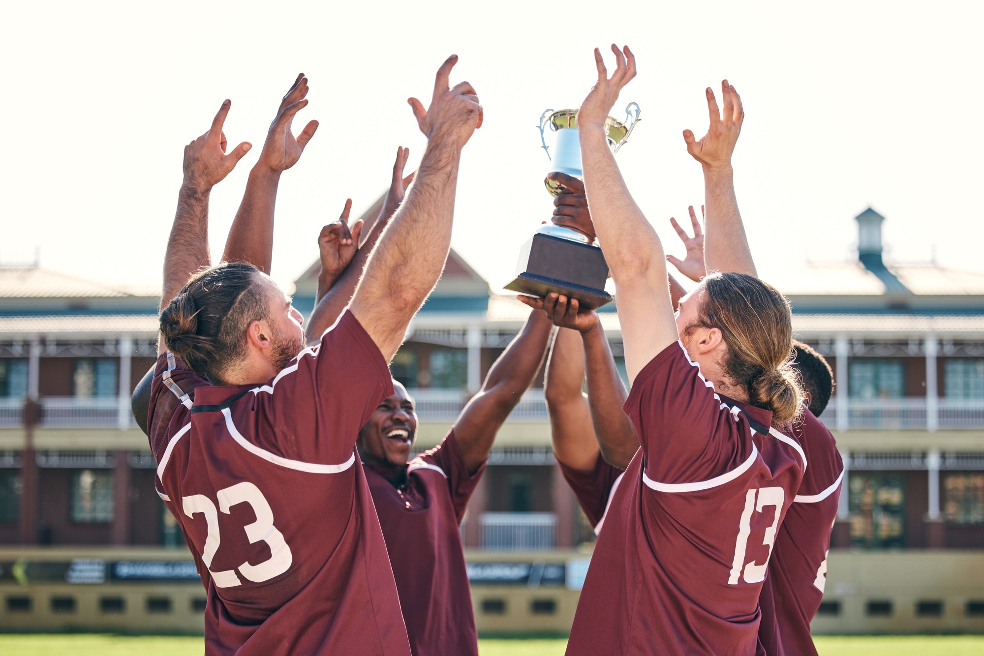 Rugby, team and winner with trophy, champion and men at stadium with success, celebration and achie